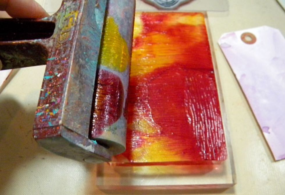 Use a brayer to spread out the paint to a thin layer, slightly mixing the two colors.
