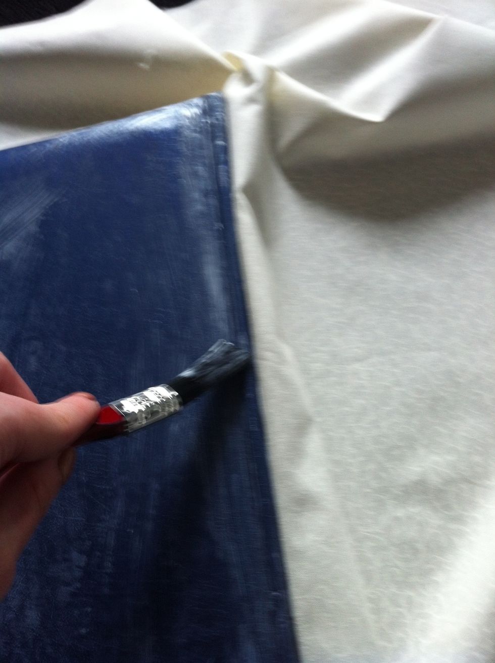 Use a brush to get in to the creases at the spine of the book