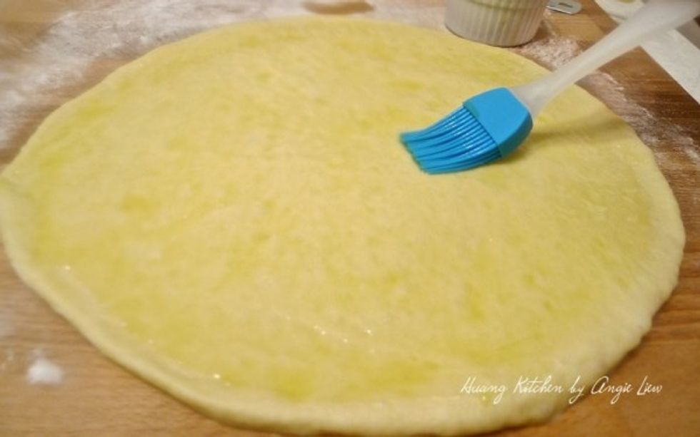 Use a brush to spread melted butter over the entire surface of each of the round dough.