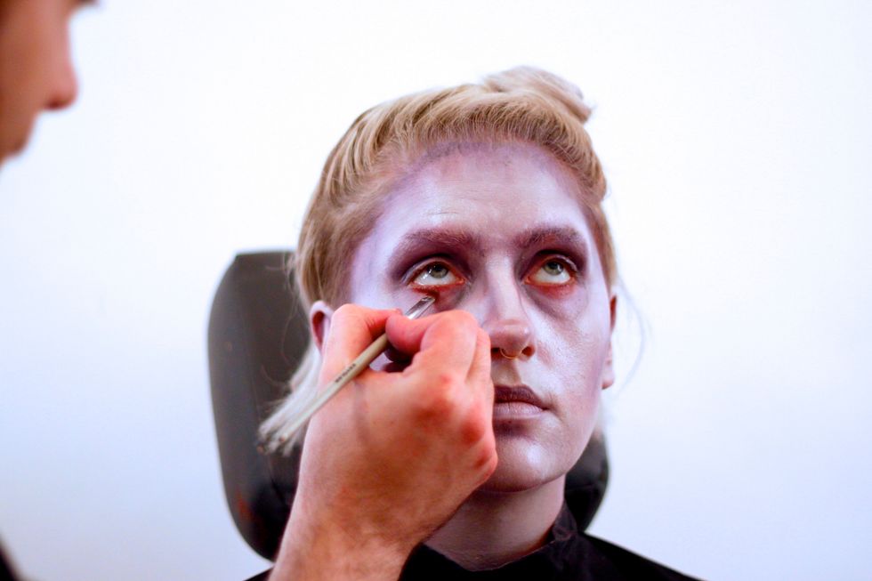 Use a burgundy color to line the eyes to make them look sunken and irritated.