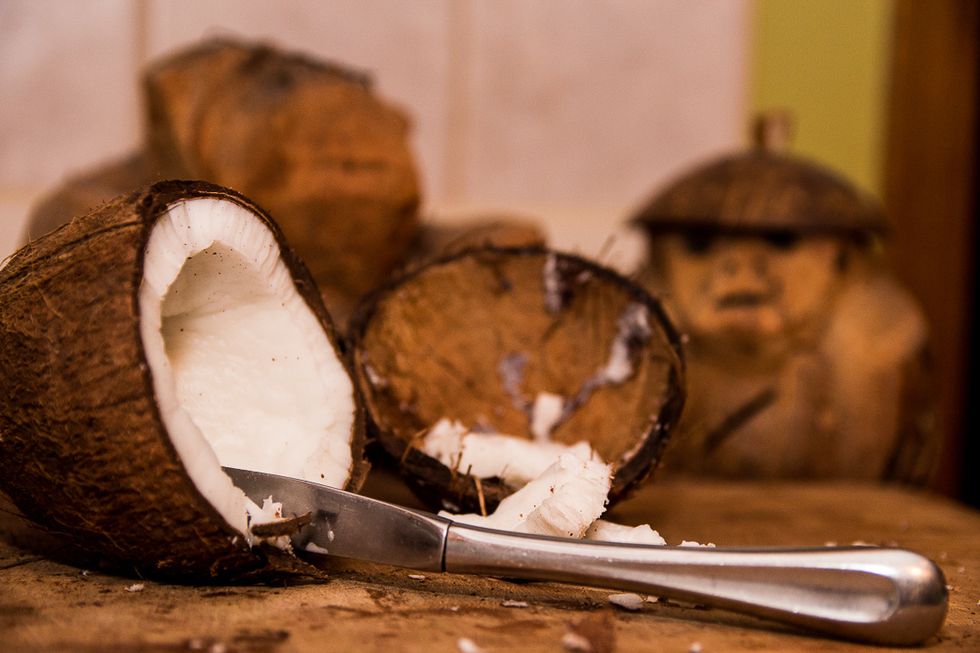 Use a butter knife and score the coconut meat in about 1 inch chunks. Getting the meat out is tricky. I am definitely game for hearing about other methods to do this part.