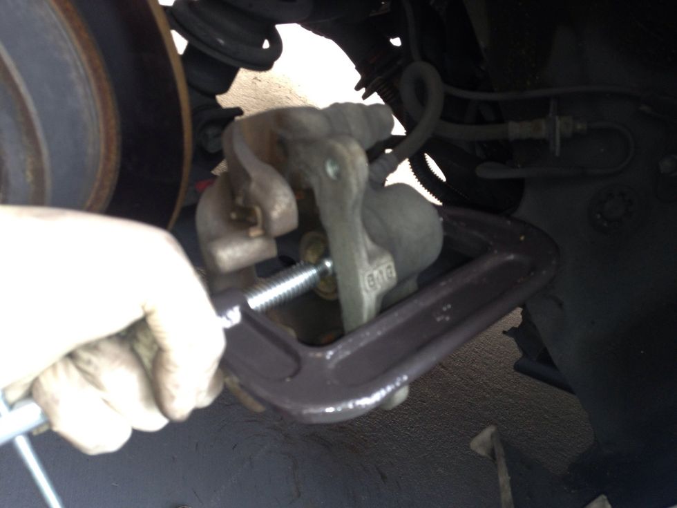 Use a C clamp to slowly wind the piston back. Doing it this way enables you to not have to bleed the brake lines