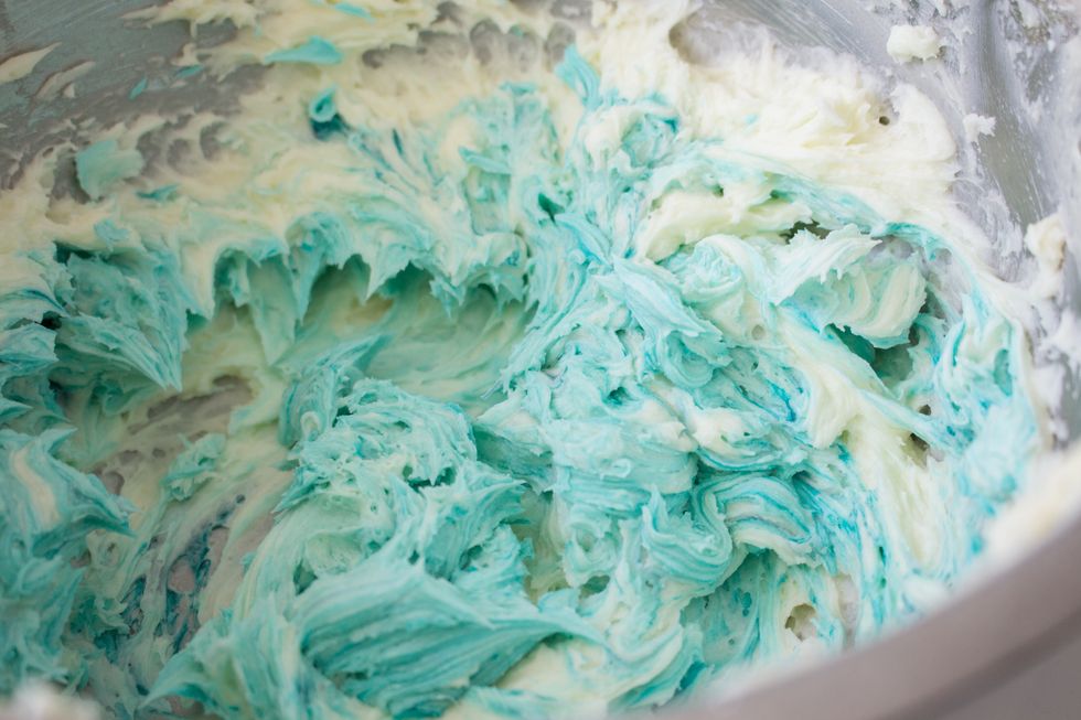 Use a cake spatula to stir in the colour. Add food colouring very little at a time. 