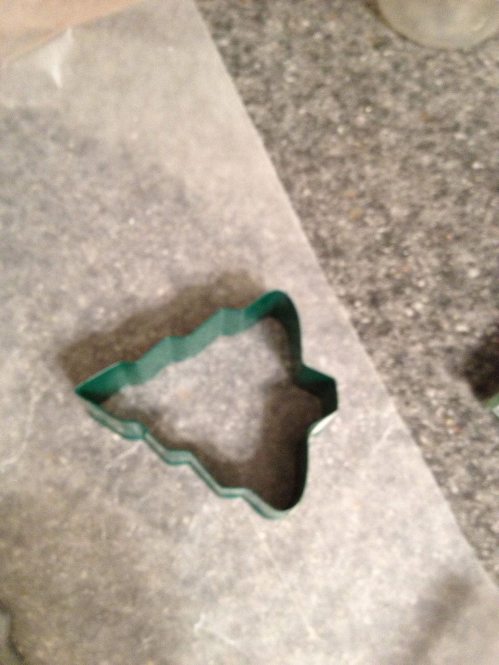 Use a cookie cutter if you want a uniform shape. You can also just flatten a ball into a circle.