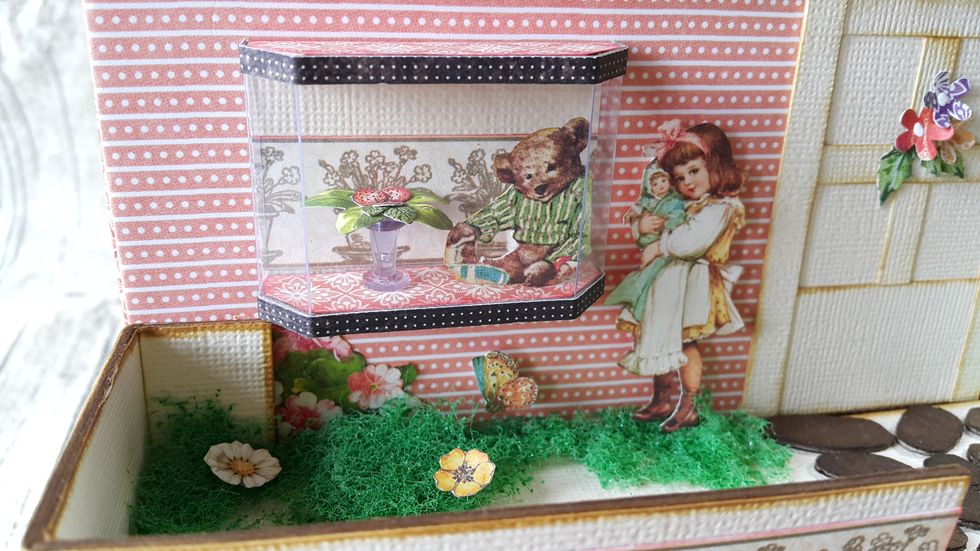 Use a corkboard pin to be the flower pot, fussy cut leaves and strawberries, fussy cut bear as window display.