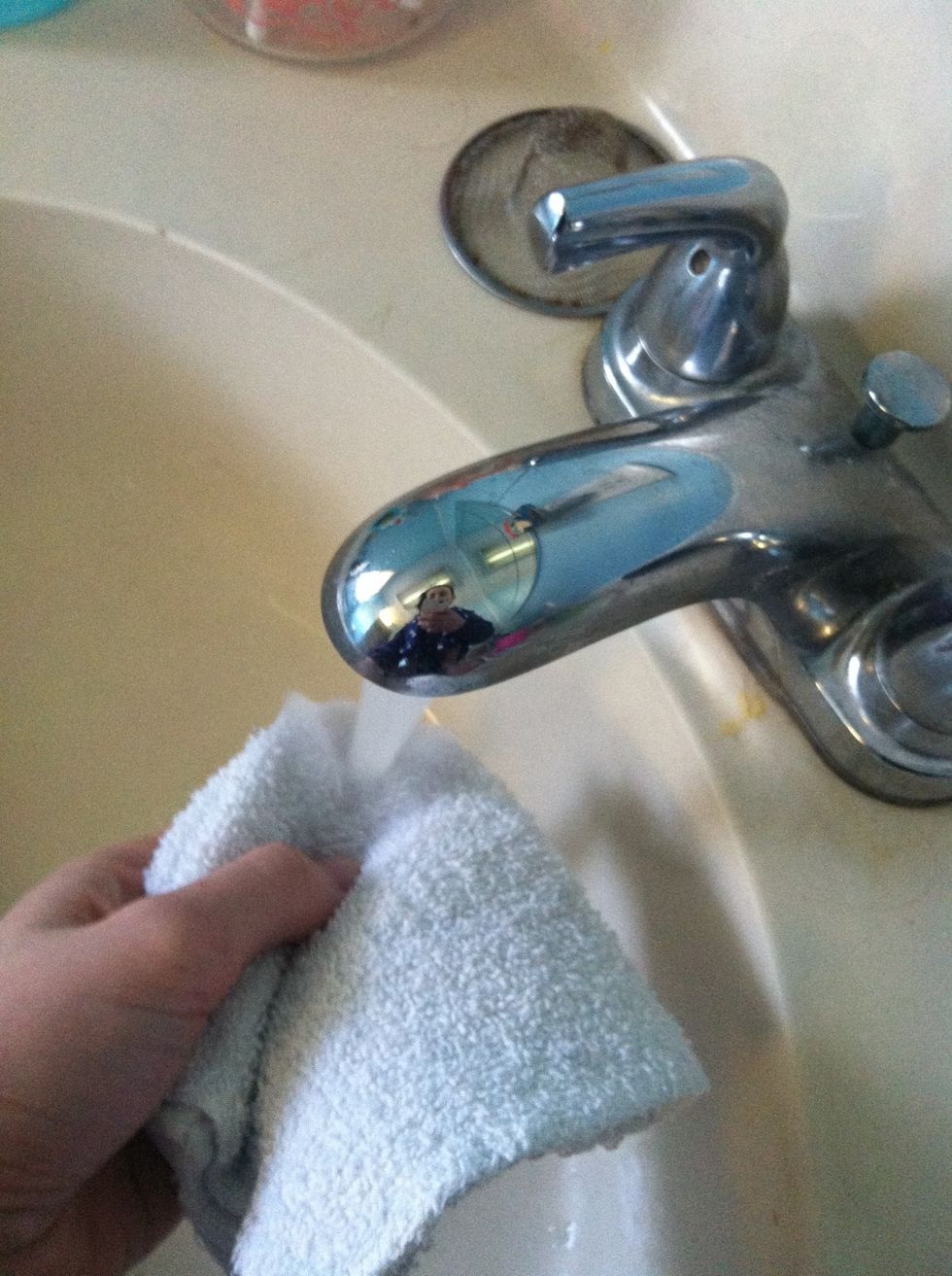 Use a corner of the wash cloth and run it under the water.