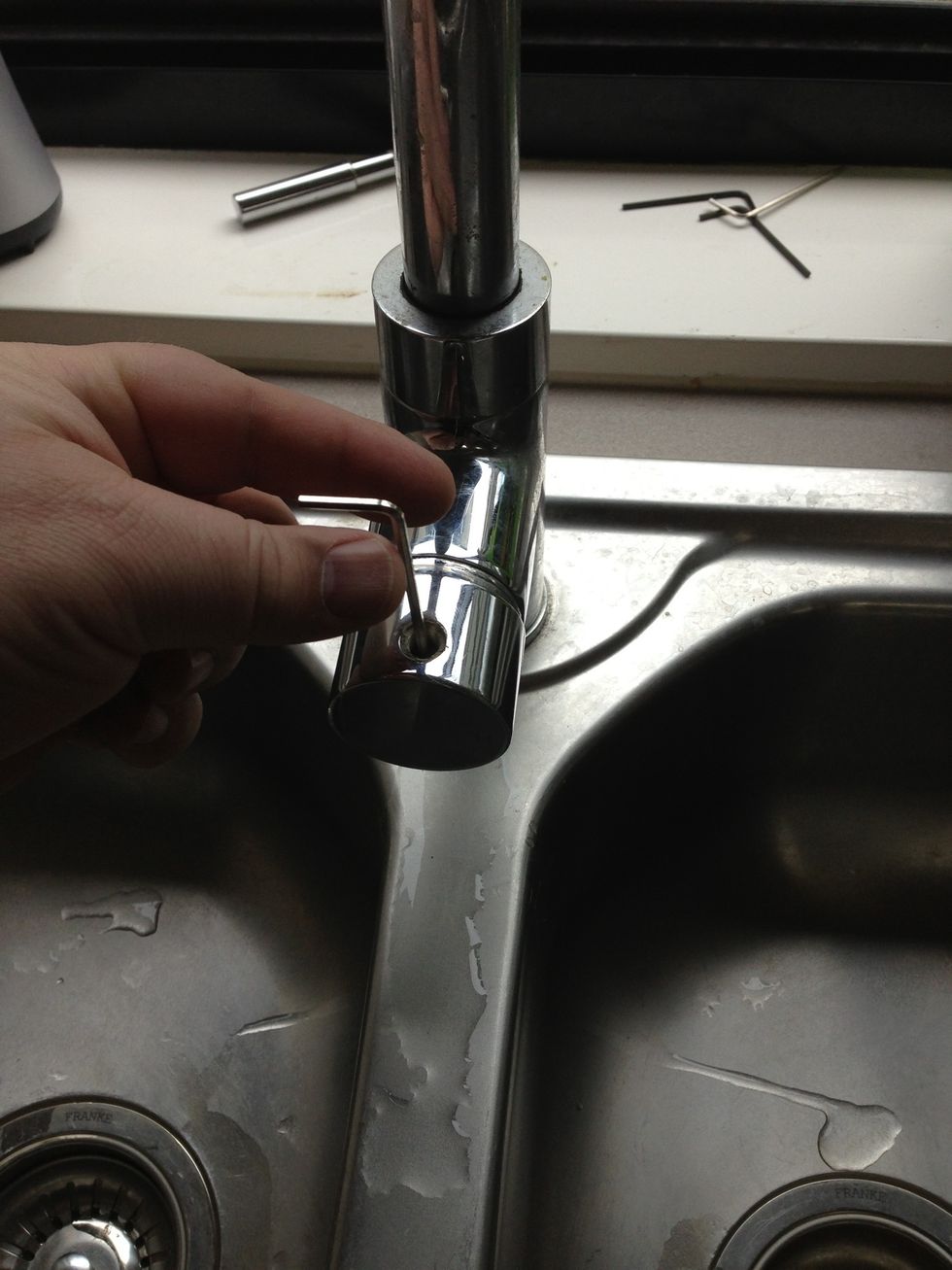 Use a correct fitting hex key (Allen key) to undo the grub screw (hex screw), it could be located where the tap handle fits or it could be located on the back side
