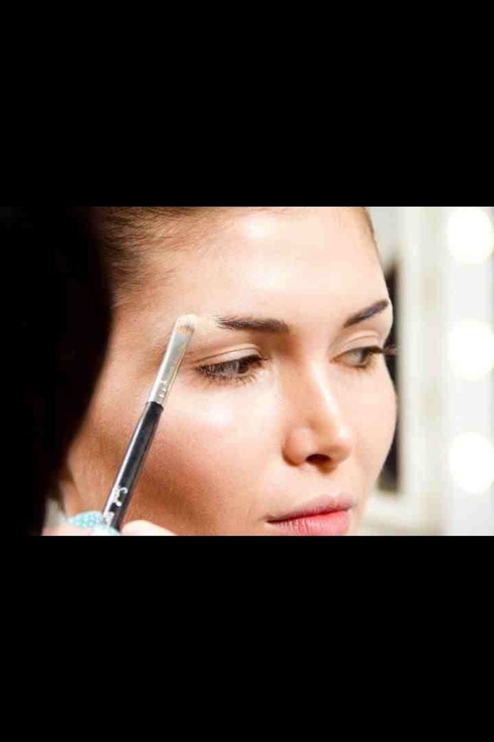 Use a cream based Kryolan ultra foundation to match the same colour as your base. Apply with a synthetic brush- dab don't drag!Use translucent powder to set the area.Repeat this step once more...