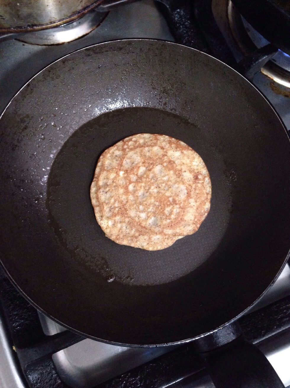 use a deeper spoon, put in the middle and grab the pan in the air and spread, back to the fire for few seconds and flip the pancake