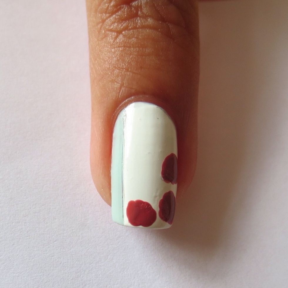 Use a dotting tool or small brush to create three rough circles using the darkest pink polish
