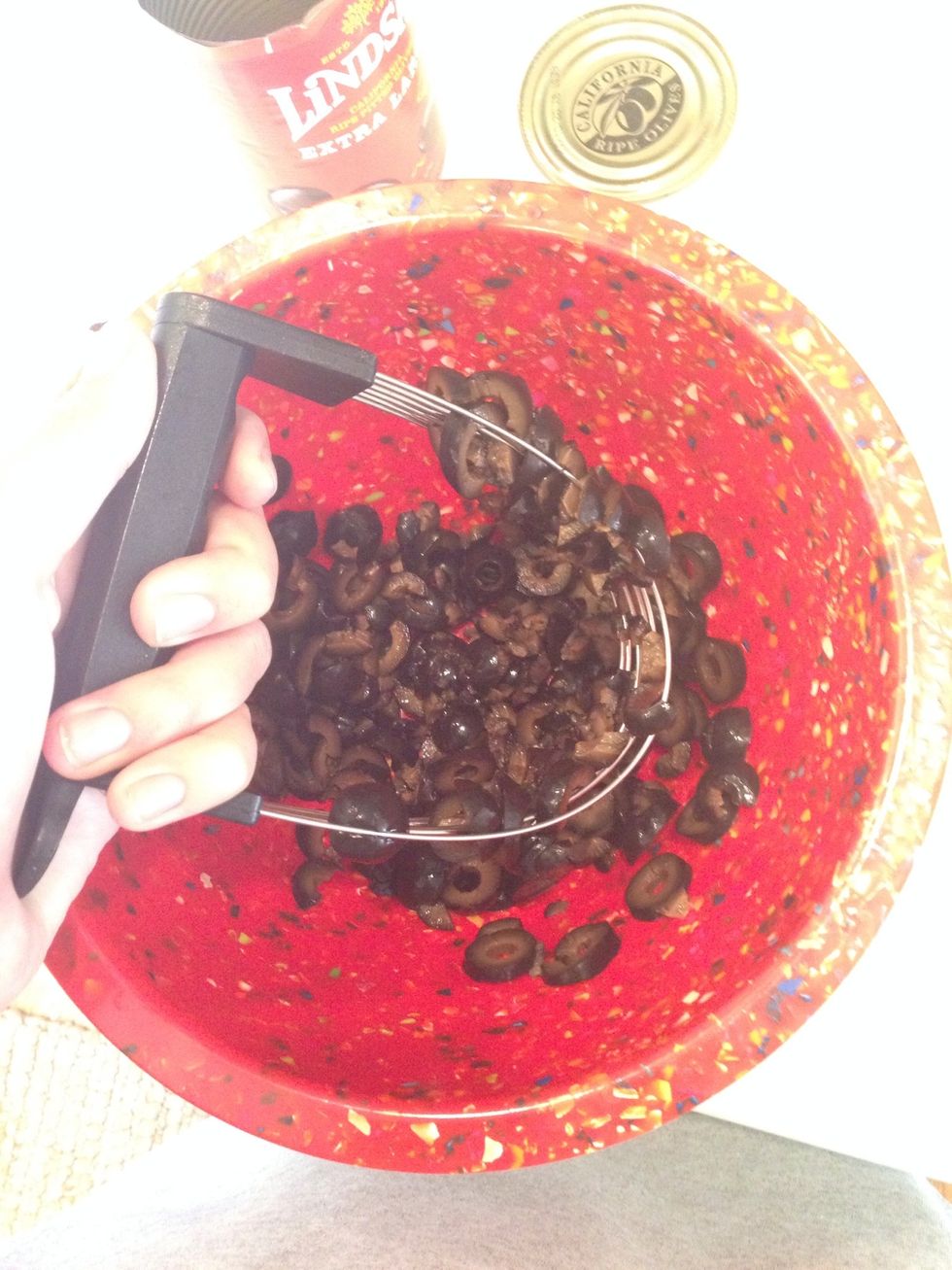 Use a dough mixer to crush the olives into smaller pieces. If you don't have one, you can use a fork.