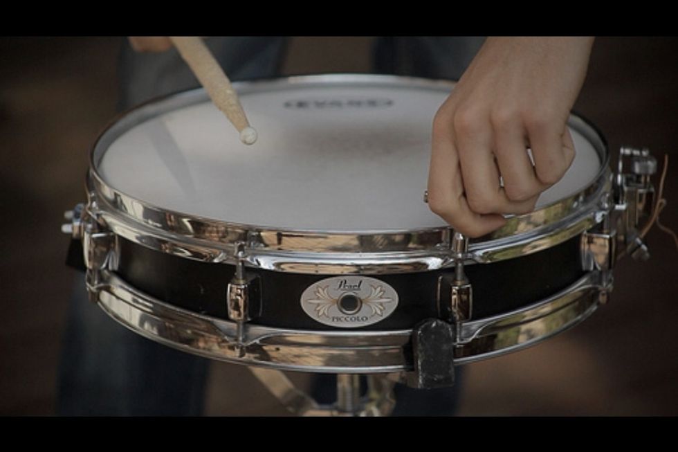Use a drum stick to tap the corners where the screws are. Make the pitch match on all of the screws. Sometimes, replacing the drum head is necessary.