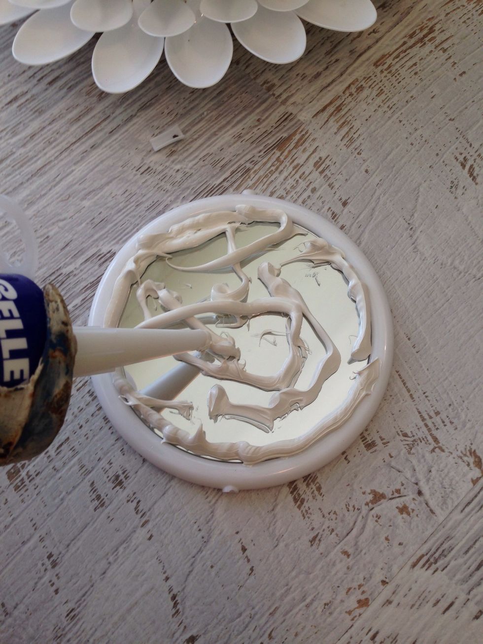 Use a firm adhesive to glue the mirror to the spoons. I used 'Selleys adhesive'.