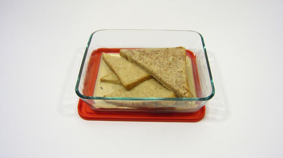 Use a flat Pyrex dish to soak the bread. Best is to use tongs to soak both sides. Do not over soak the bread otherwise the bread will break as you move it into the pan to fry.