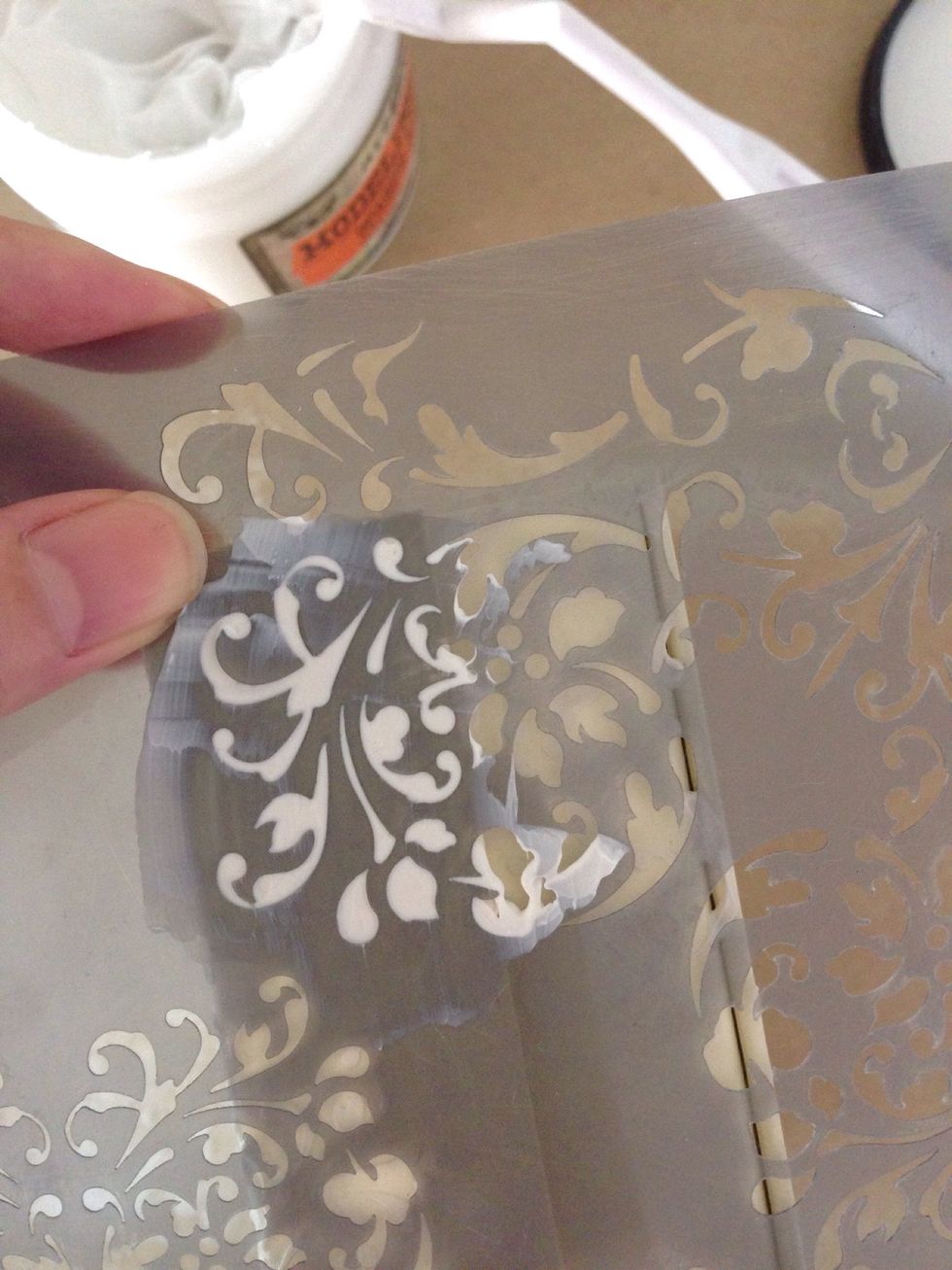 Use a flourish stencil, apply modeling paste over it randomly around the box...