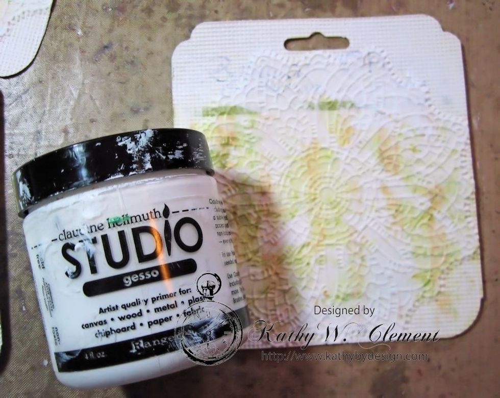 Use a foam brush to add a light coating of gesso on the edges of the tag to cover up the printing.