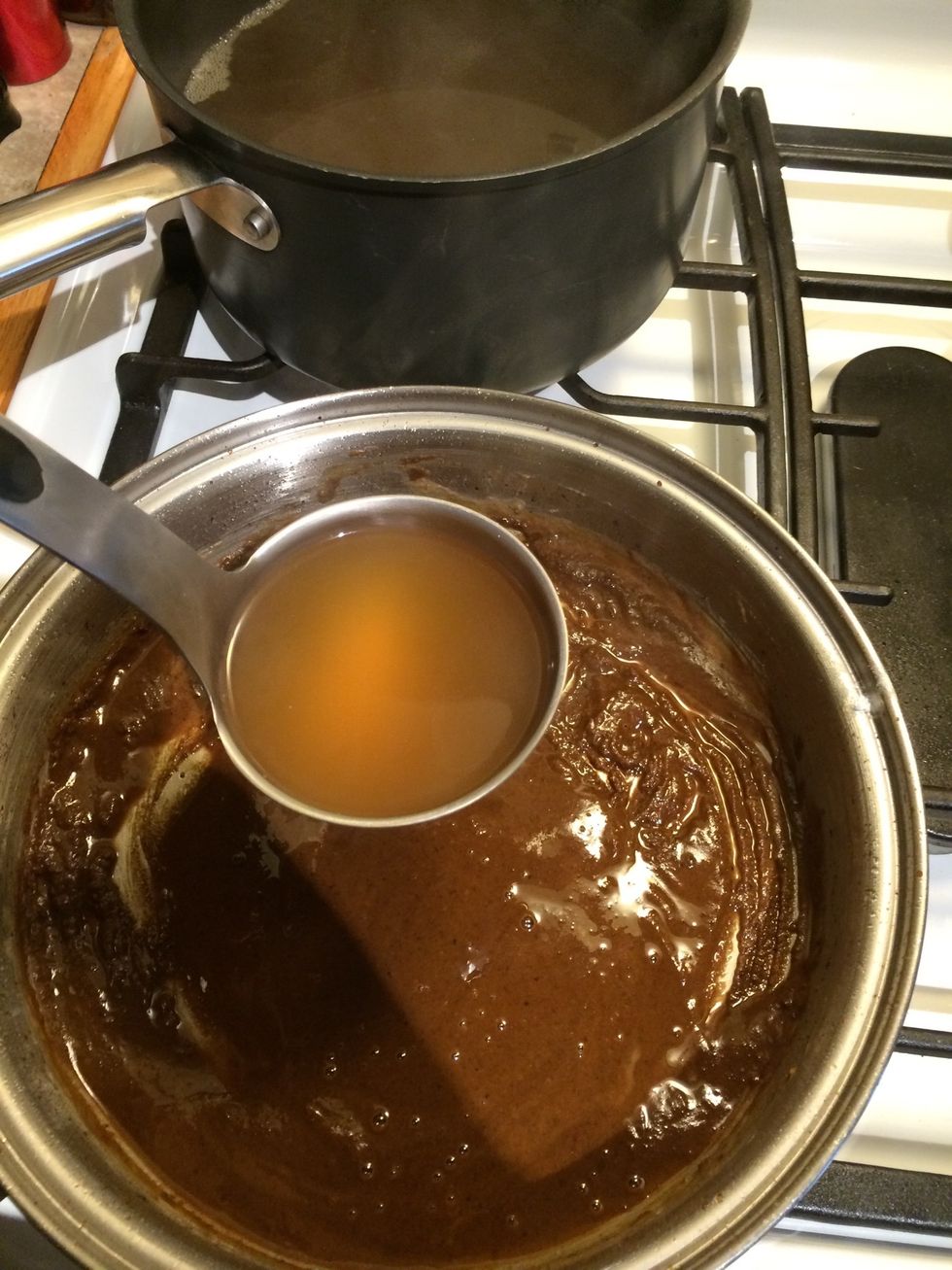 Use a fork and blend the stock and the roux together. Be careful not to go to fast. You are looking for a a thick liquid. Then add to pot of shrimp and veggies.