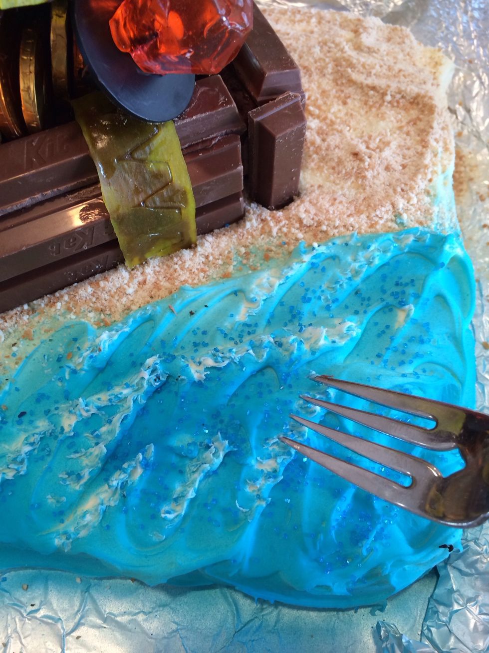 Use a fork to add white caps to the waves, and add blue sprinkles.