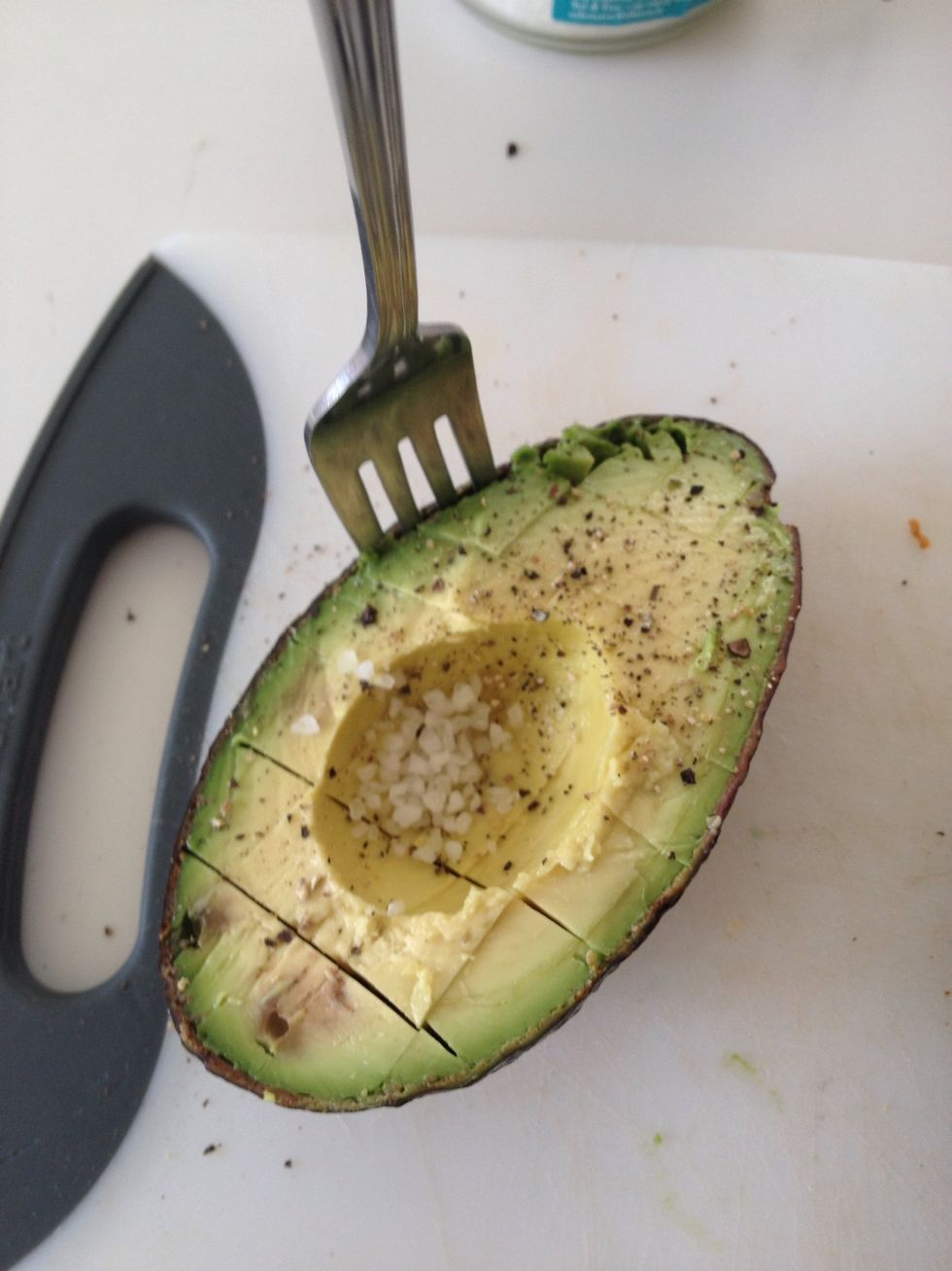 Use a fork to detach the cubes from the skin of the avocado.