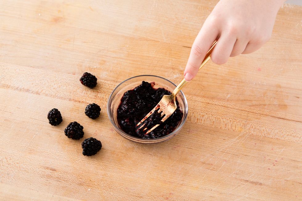 Use a fork to mash up 1/2 cup of blackberries.