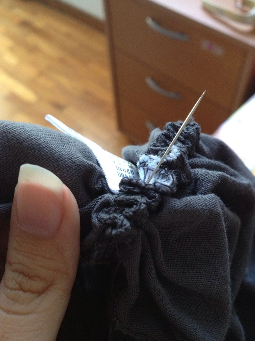 Use a fresh piece of thread to specially stitch through the clothes tag area, until the scrunch is tight enough.