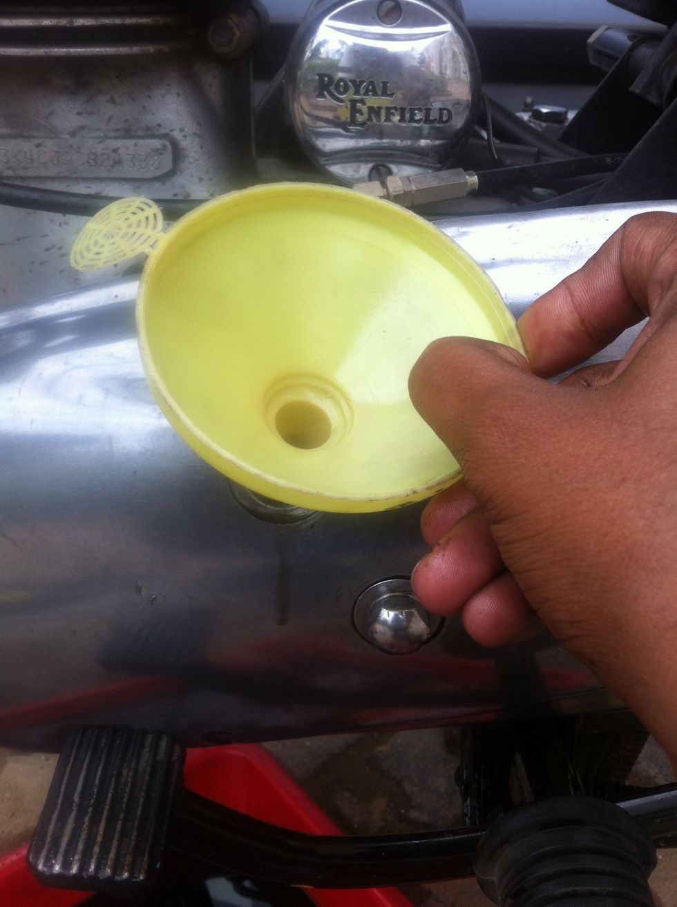 Use a funnel to pour oil