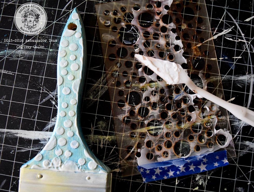 Use a gel medium through a stencil, any stencil. Whatever floats your boat is perfectly acceptable. I used one that reminded me of bubble because, you know, ocean theme and all.