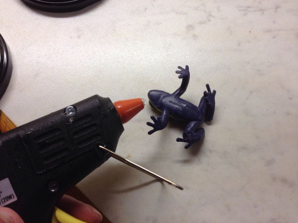 Use a glue gun to attach the plastic animals to the lid.