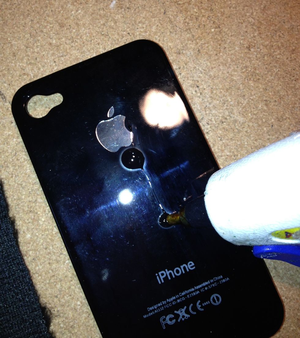 Use a glue gun to glue the fabric onto the back of the iPhone case you've chosen.