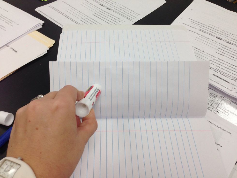 Use a glue stick to apply glue on the backside of the folded paper