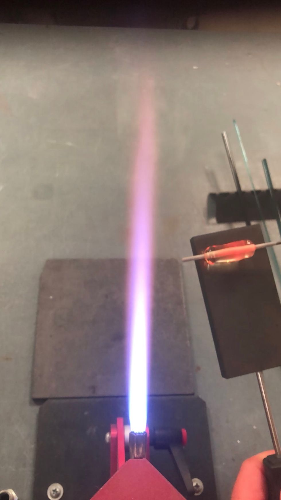 Use a graphite paddle to gently marver the first end until it\u2019s cylinder shaped. I find it helpful to let the surface cool for a few seconds before using the paddle.