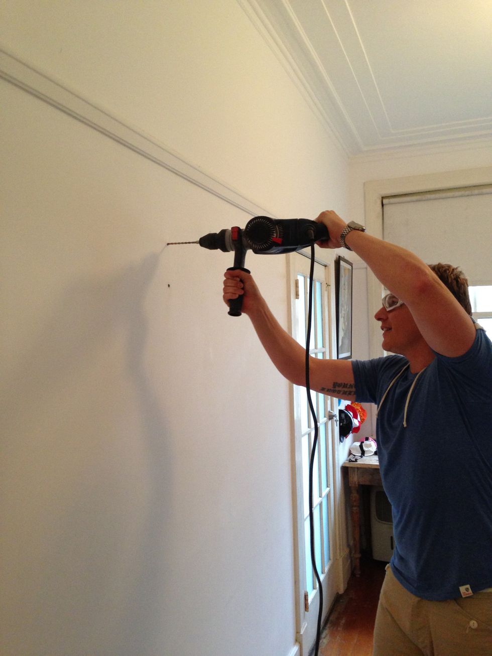 Use a hammer drill to drill holes into the wall marks you have made