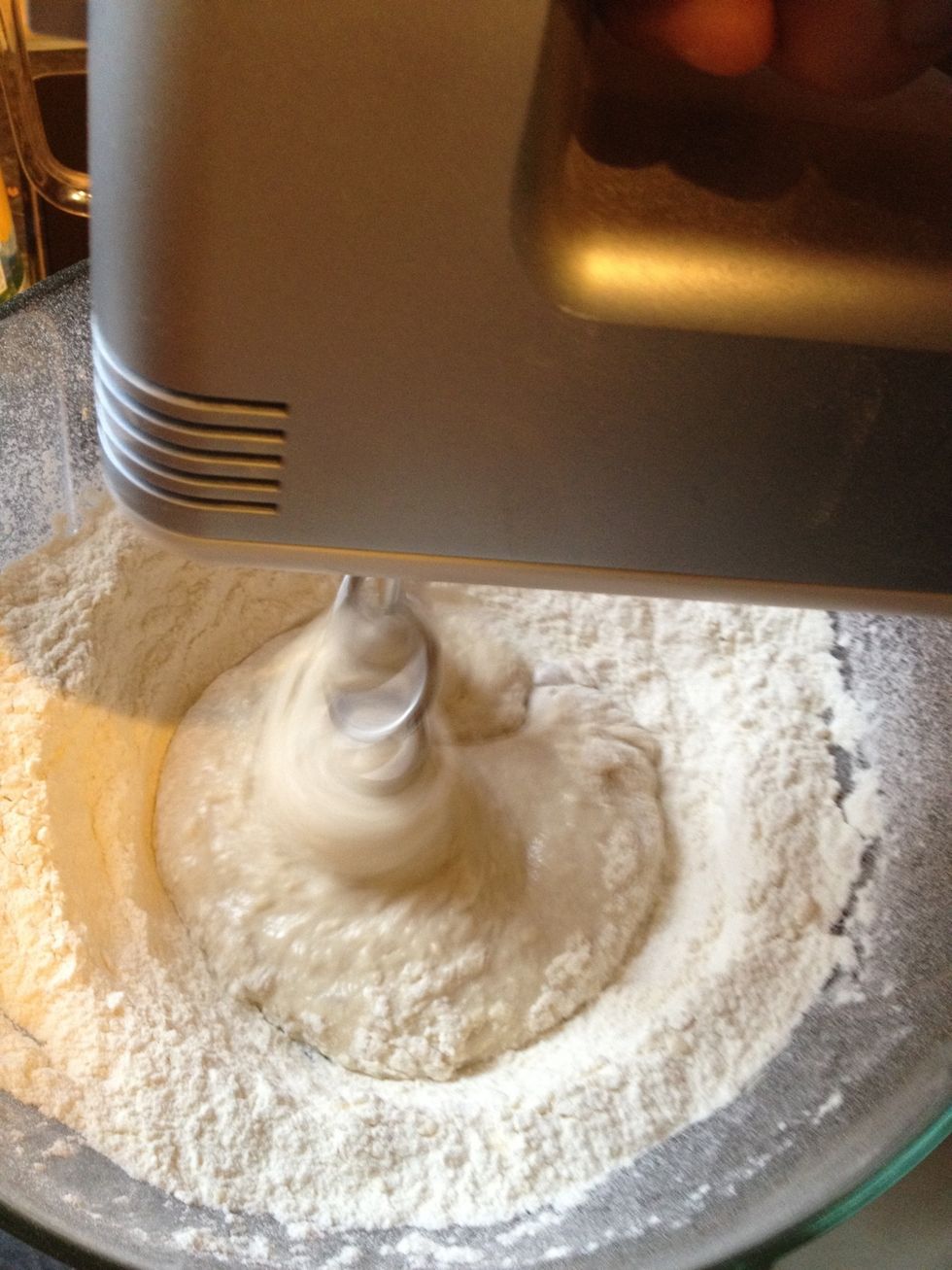 Use a hand mixing machine, start only in the middle and work in more and more of the flour/sugar mix. In the beginning the dough is very soft almost liquid.