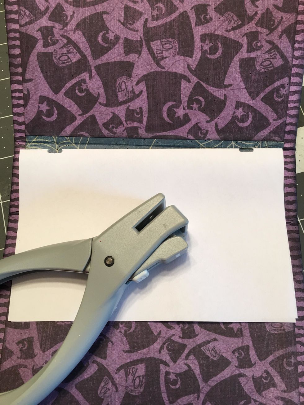 Use a hole punch or a notch punch as shown to punch a hole at each mark on the template paper.