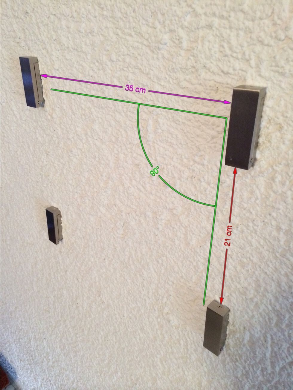 Use a horizontal distance of 35 centimeters (14 inches) and a vertical distance of 21 or 22 centimeters (9 inches) between the hooks. This is a golden ratio and will look natural.