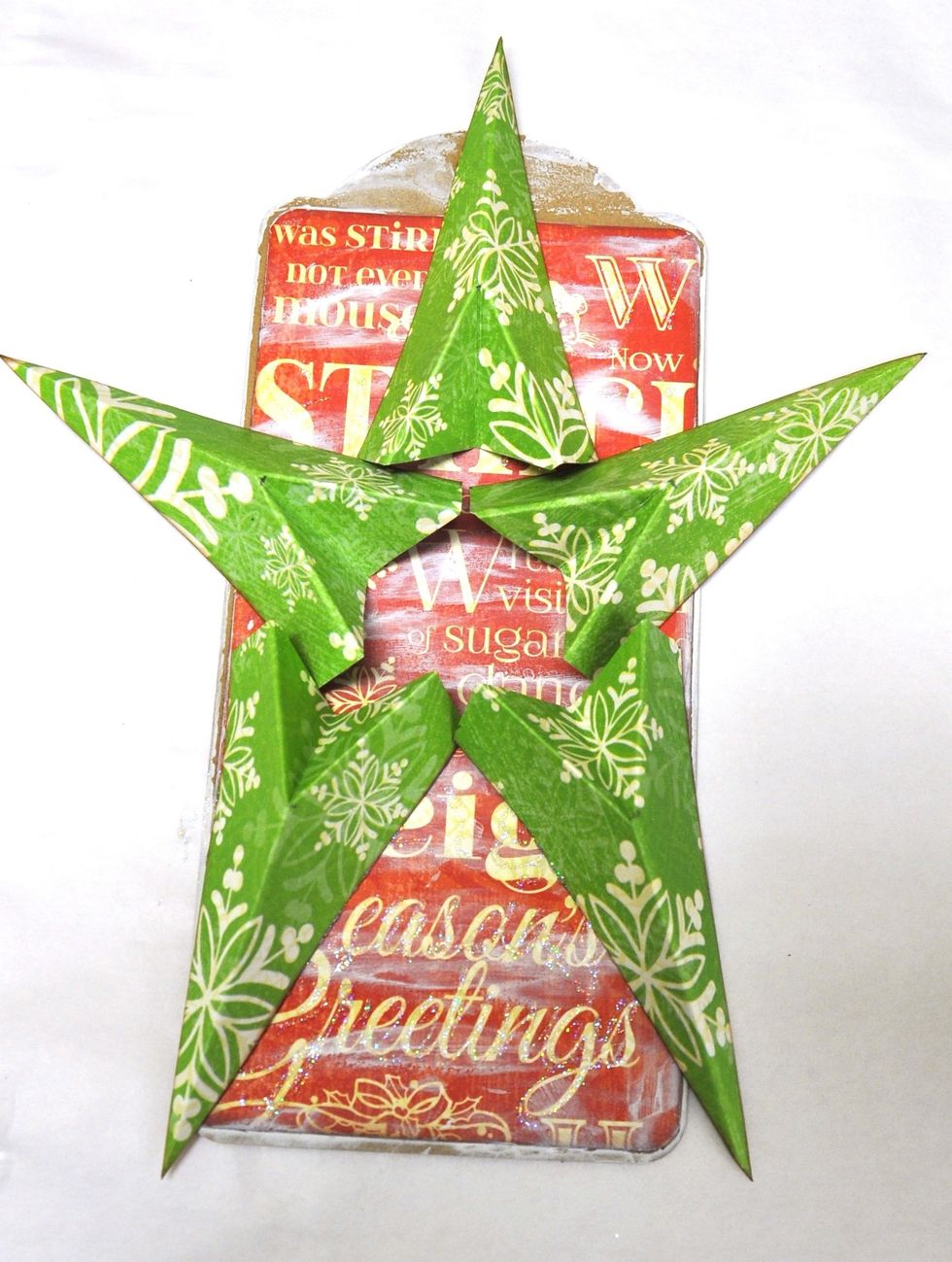 Use a hot glue gun and glue your five star pieces onto your tag.