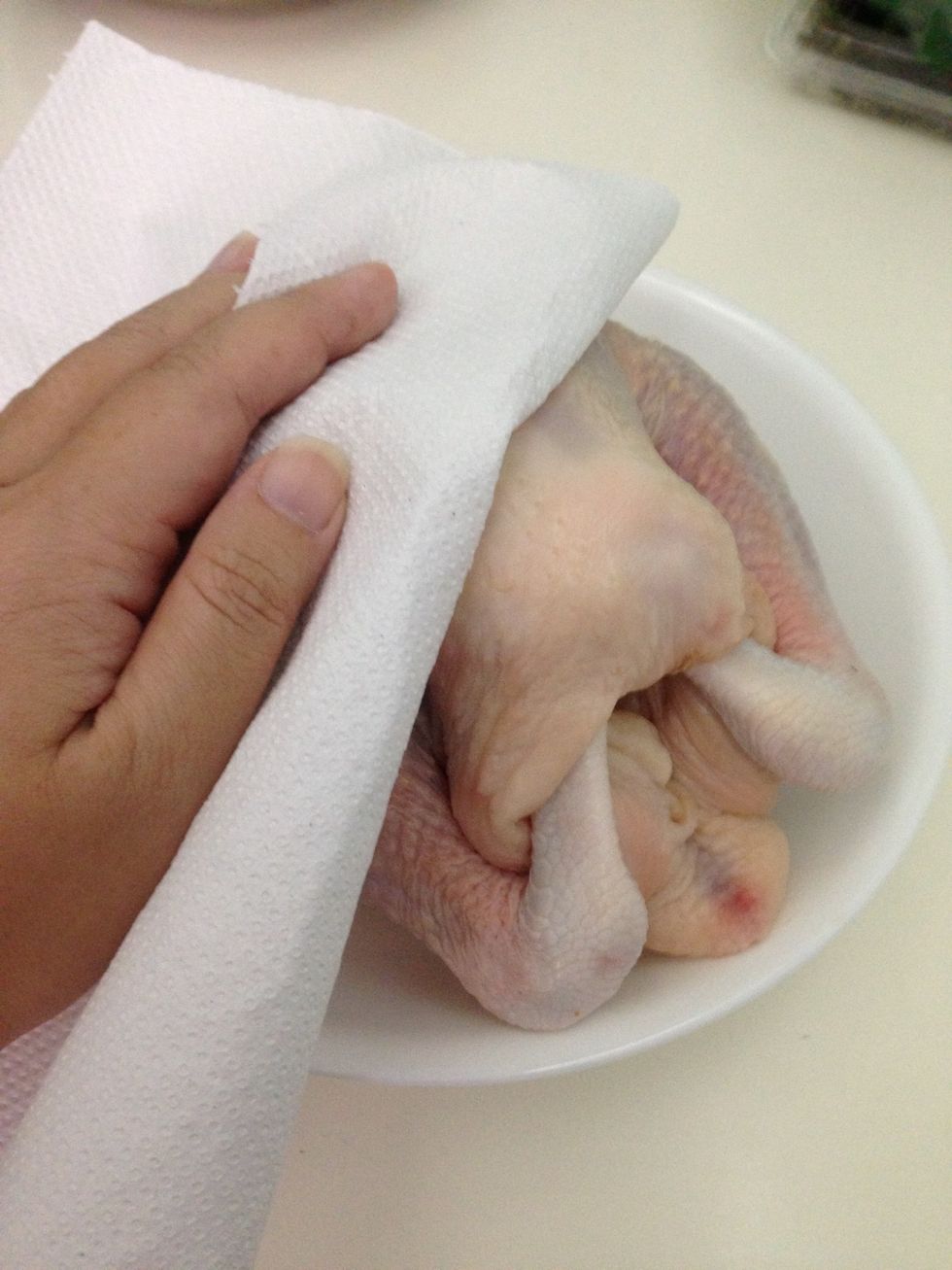 Use a kitchen towel to dry the chicken