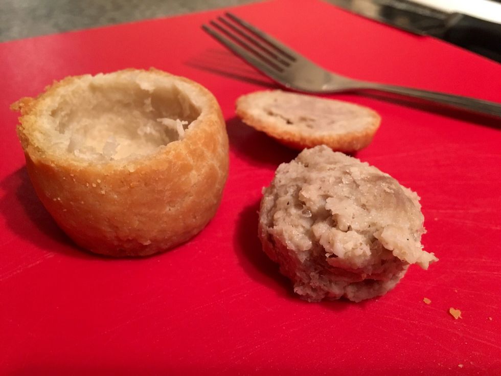 Use a knife and cut around the meat inside the pie, using a fork remove the meat from the centre