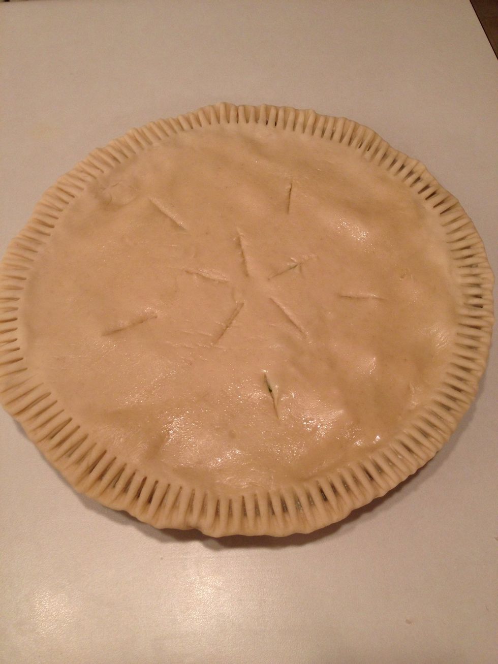 Use a knife to cut air vents in a symmetrical pattern on the top crust.