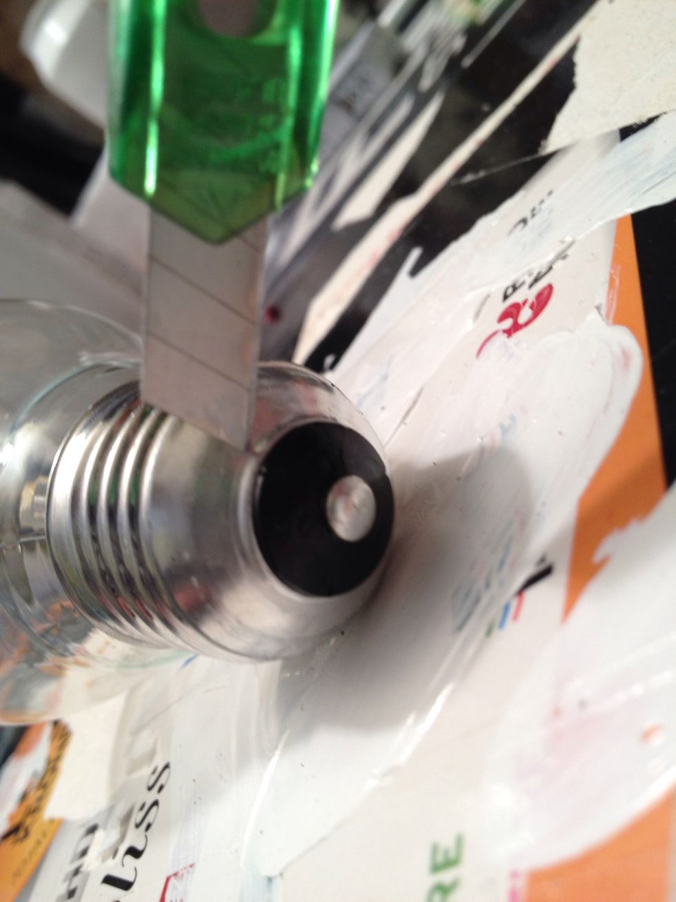 Use a knife to cut open the bulb. Cut as close as possible to the black center