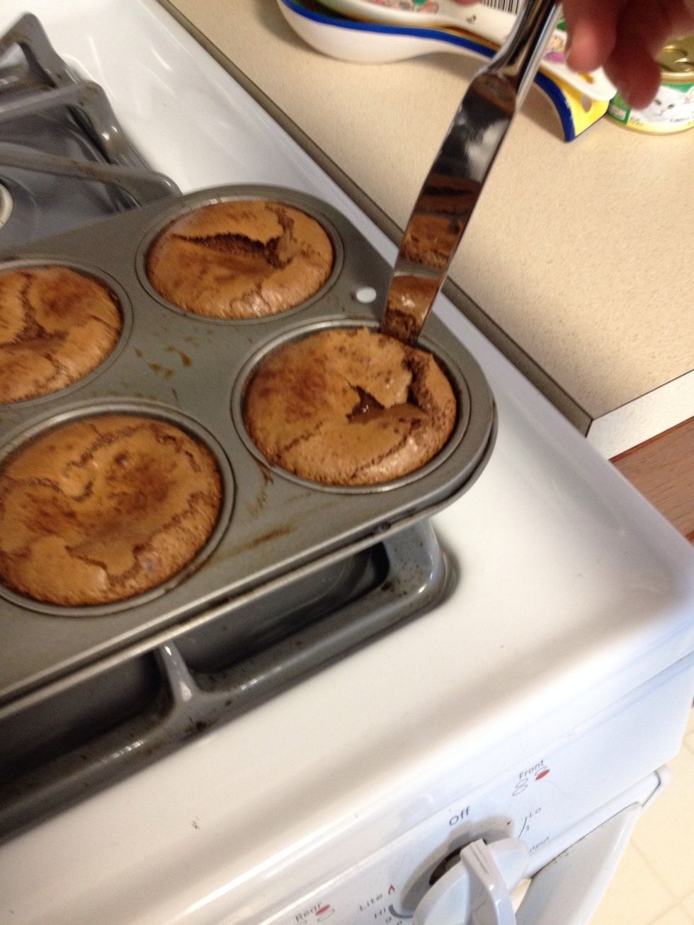 Use a knife to loosen the sides and then put a flat plate on top of the tin and flip over