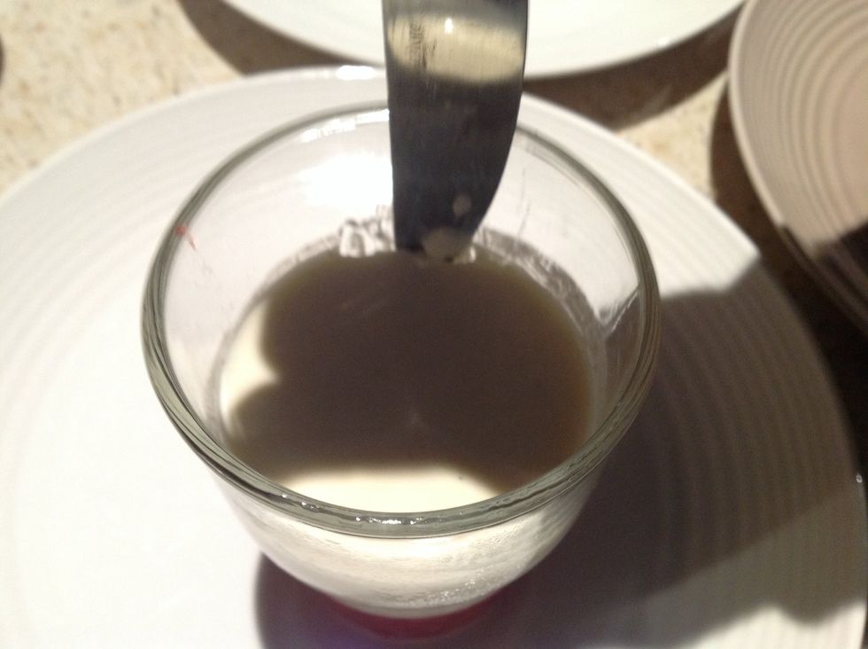 Use a knife to scrape around the edge of the glass and then tip it over on top of a plate so that it comes off the glass.