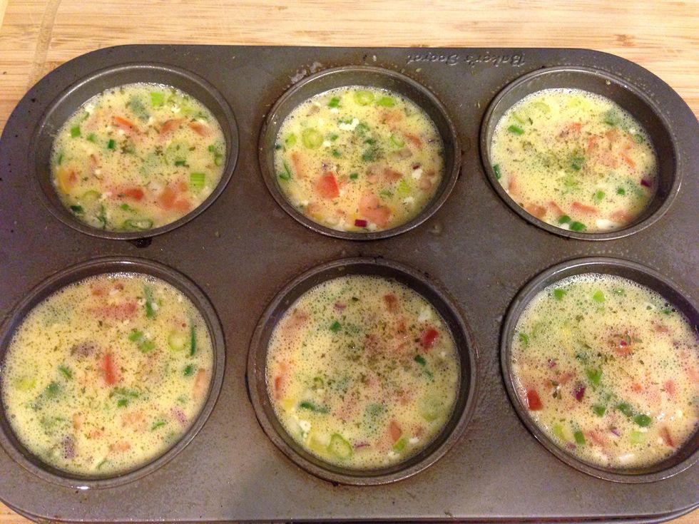 Use a ladle, and spoon out egg mixture into muffin cups. You should have just enough to fill a 6 cup pan. Sprinkle each omelette with a little dried parsley.