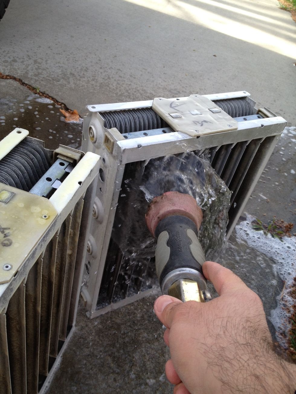 Use a low to medium pressure garden hose to wash the solution off. Flip over and repeat. The idea here is to remove all the solution.
