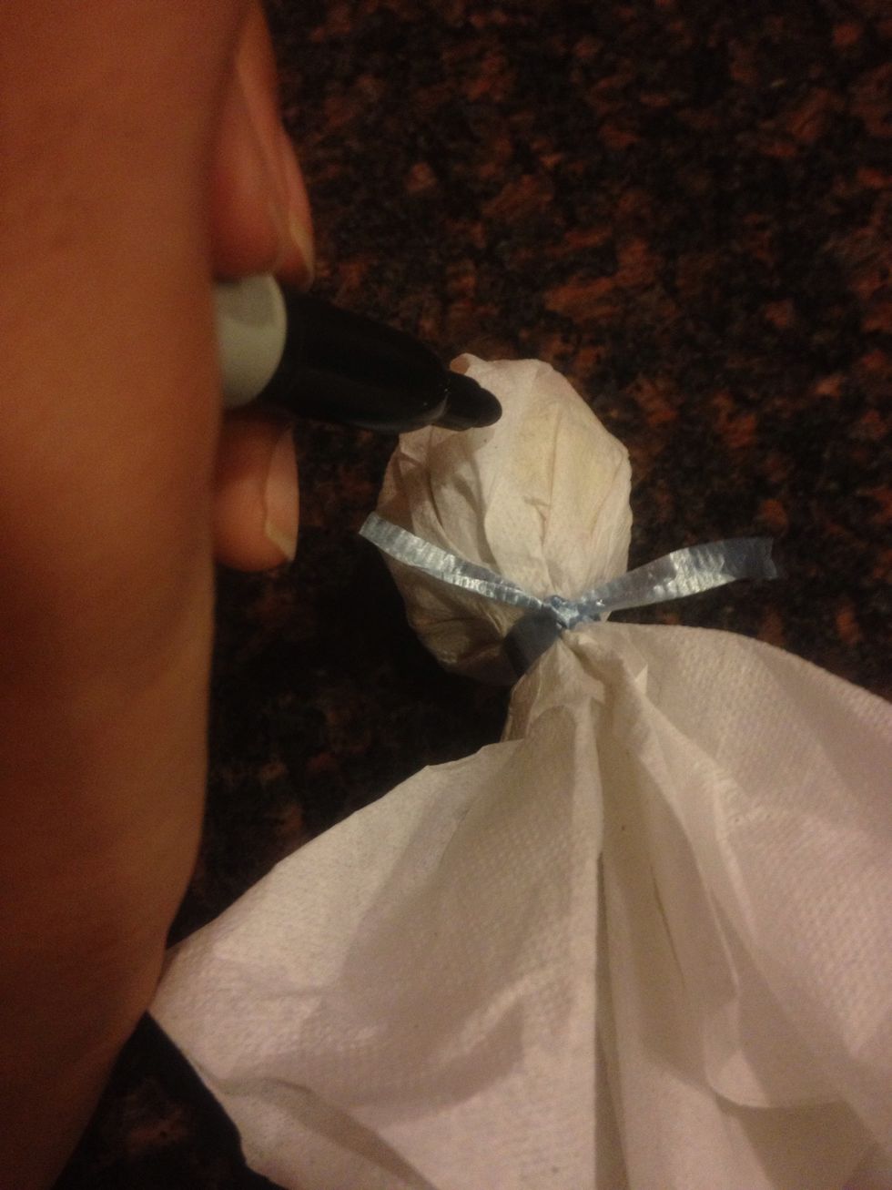 Use a marker to draw a face (or anything) on your "ghost"