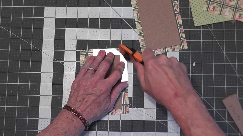 Use a mitering tool or your ruler to angle cut all four corners.  You will want the cut to be about 1/8" from the tip of each corner.
