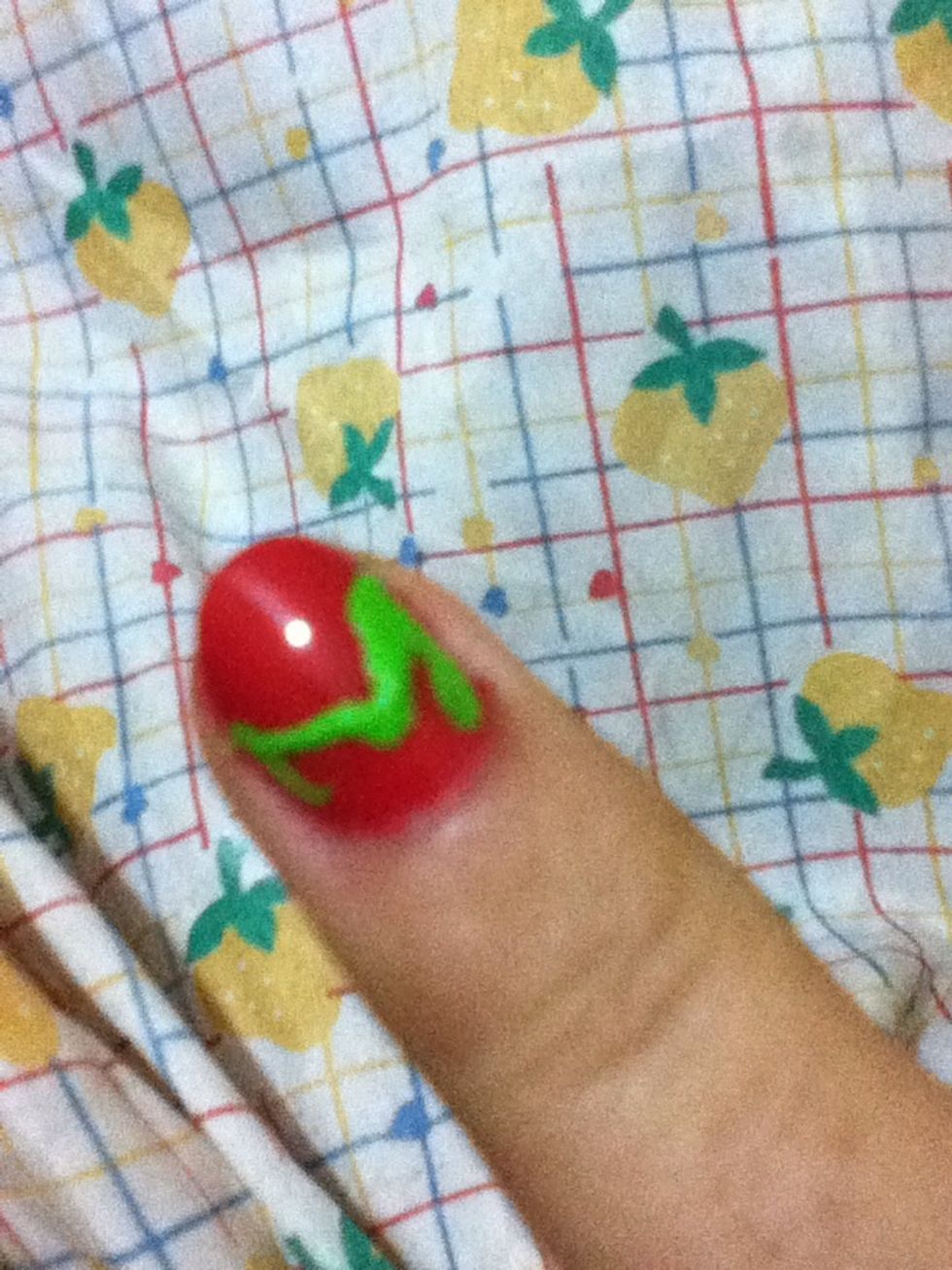 Use a nail art brush and green nail polish to make the leaves of the strawberry. If you don't have a nail art brush you can use a thoothpick