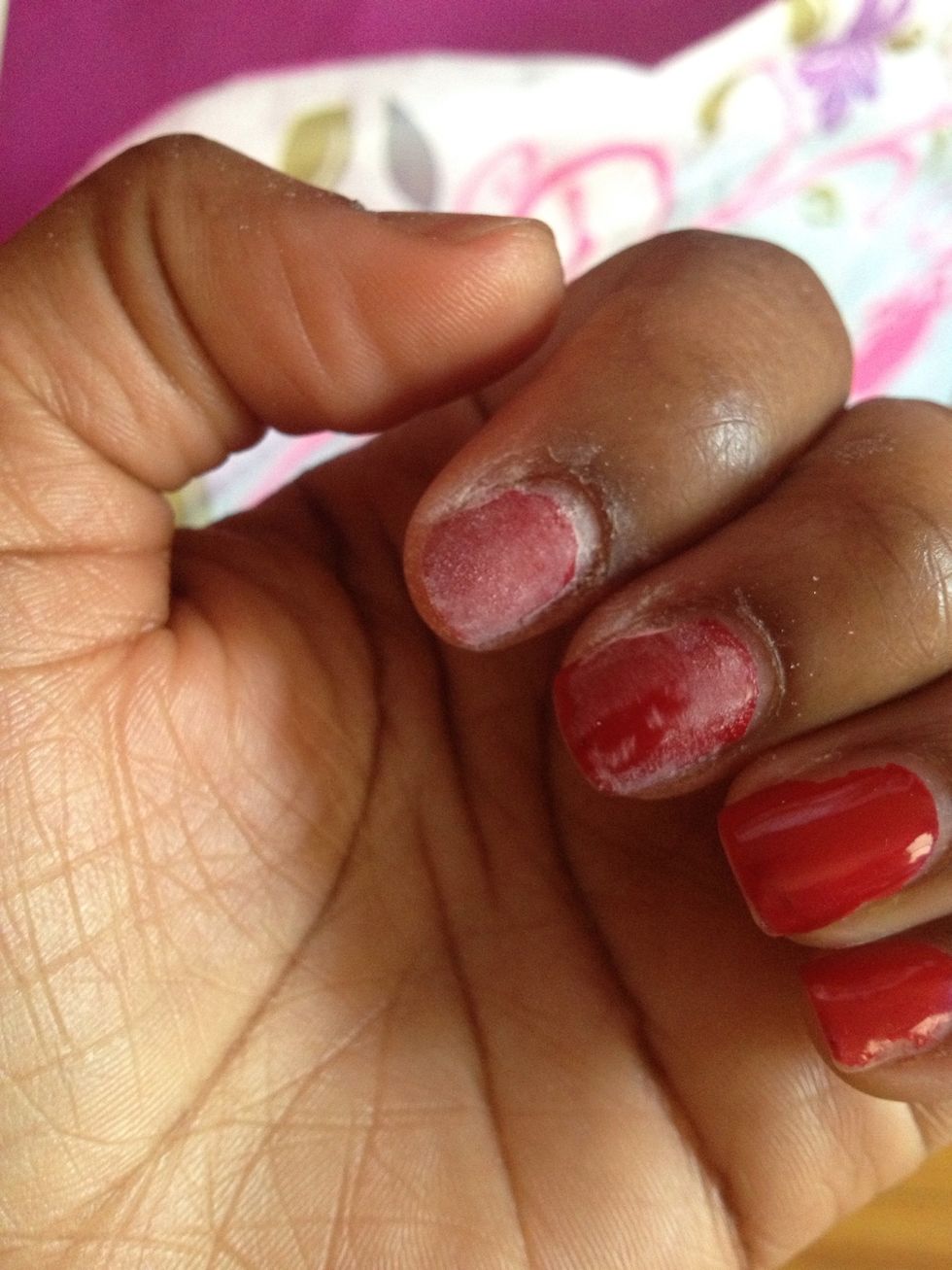 Use a nail buffer to break the top coat