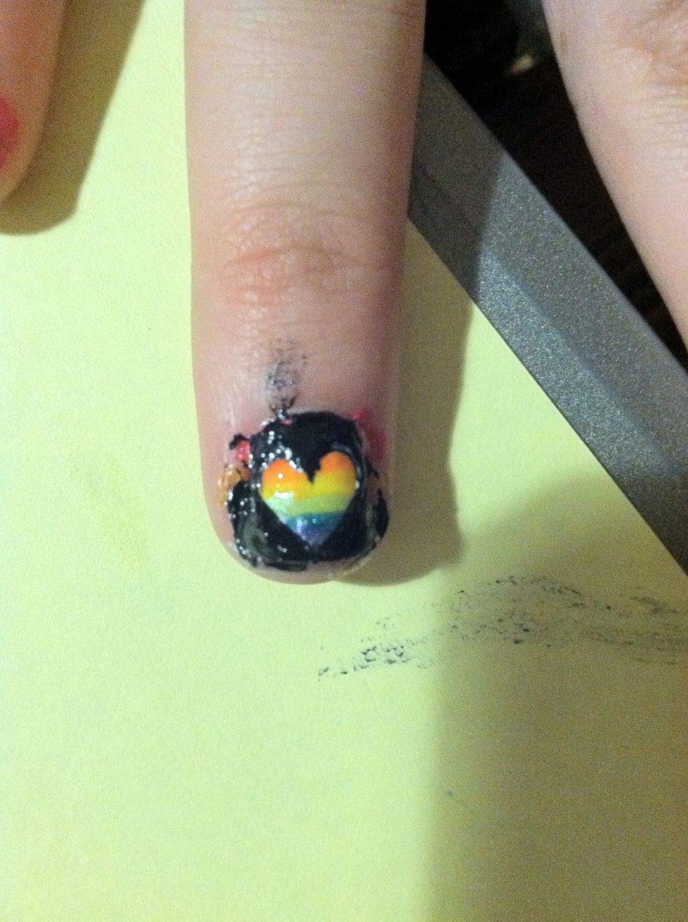 Use a nail pen or a toothpick to draw a heart then paint around it for a simple cut out on your ring finger.