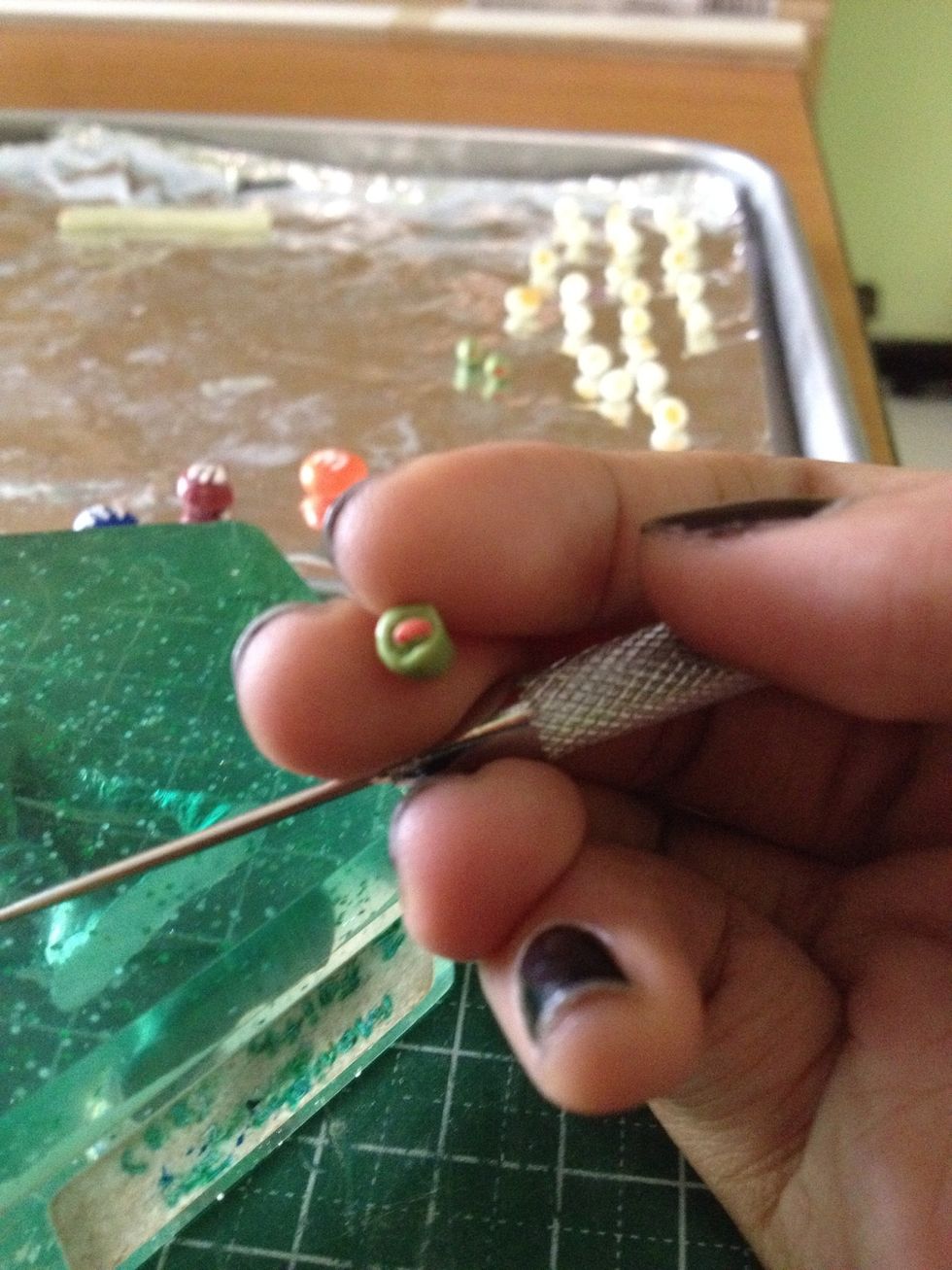 Use a needle tool to outline the filling, making it stand out from the olive clay. Then use a ball tool to flatten the filling, making the olive edges out stand.